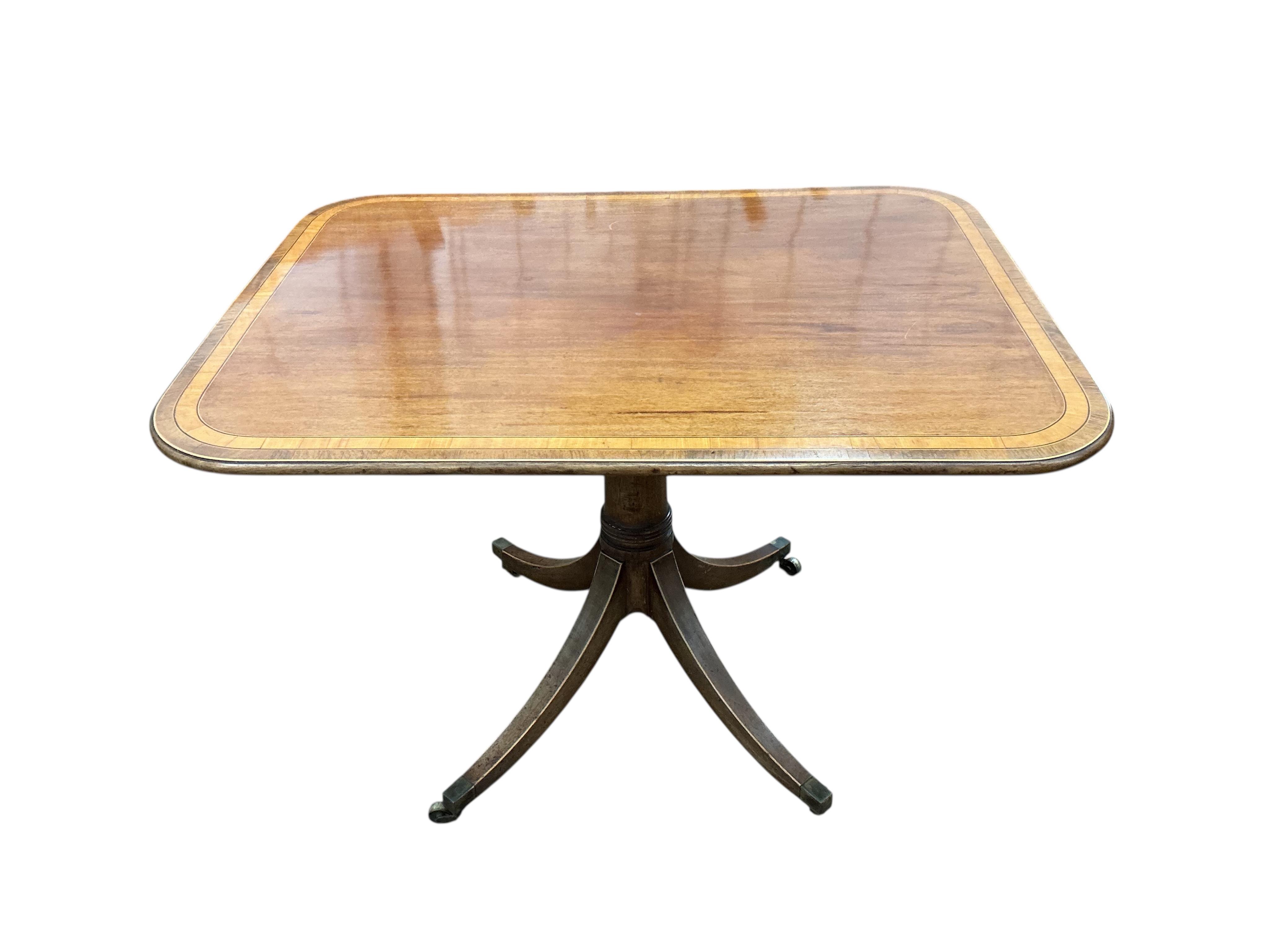 A Regency satinwood banded rectangular mahogany tilt top dining table, on four outswept legs, width 82cm, depth 104cm, height 72cm
